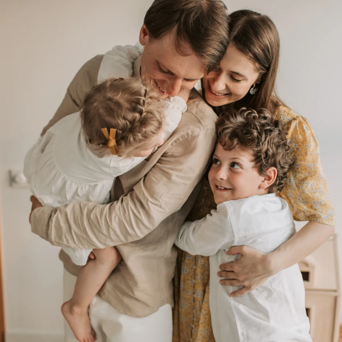 A family embracing one another at home