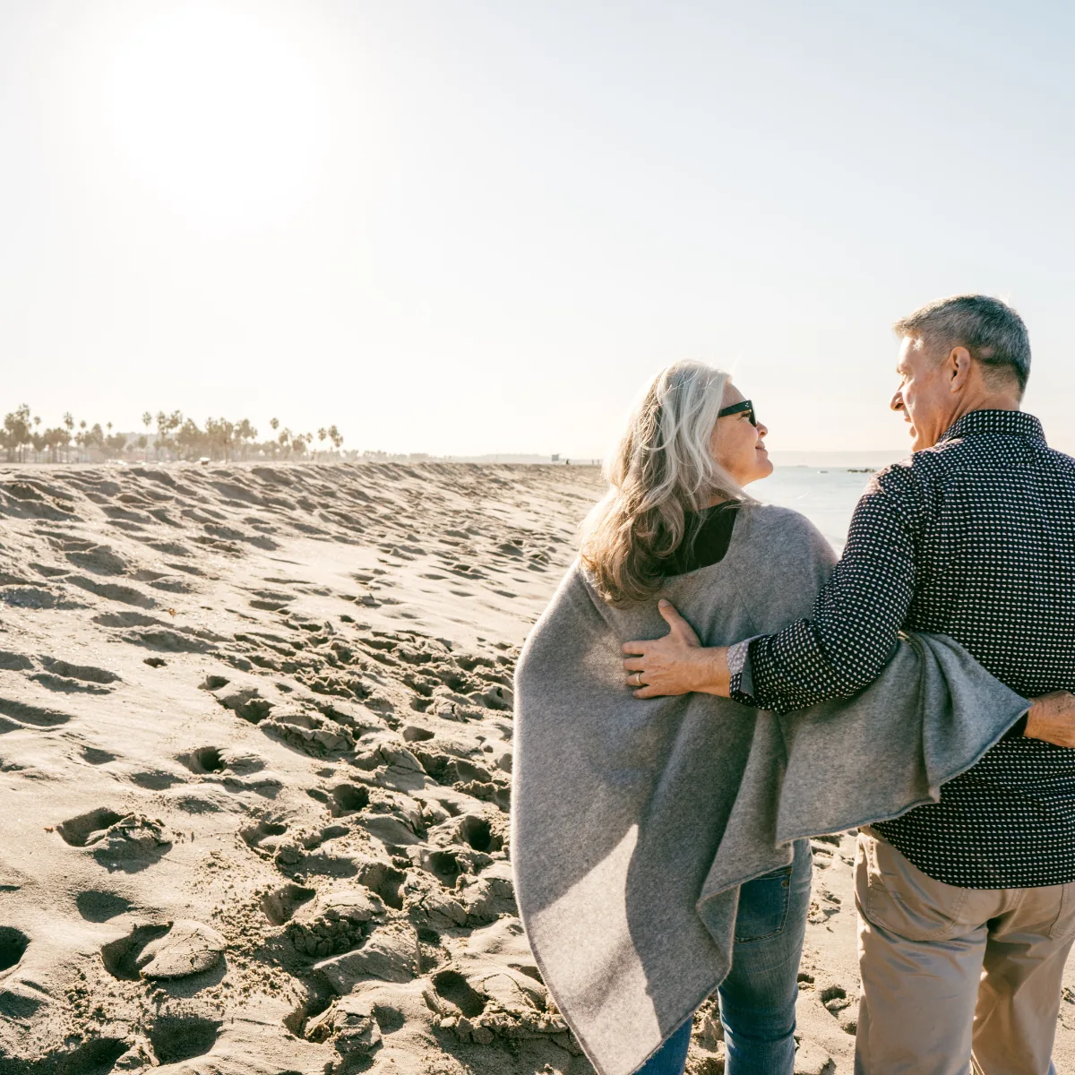 A couple walking together along the beach at golden hour